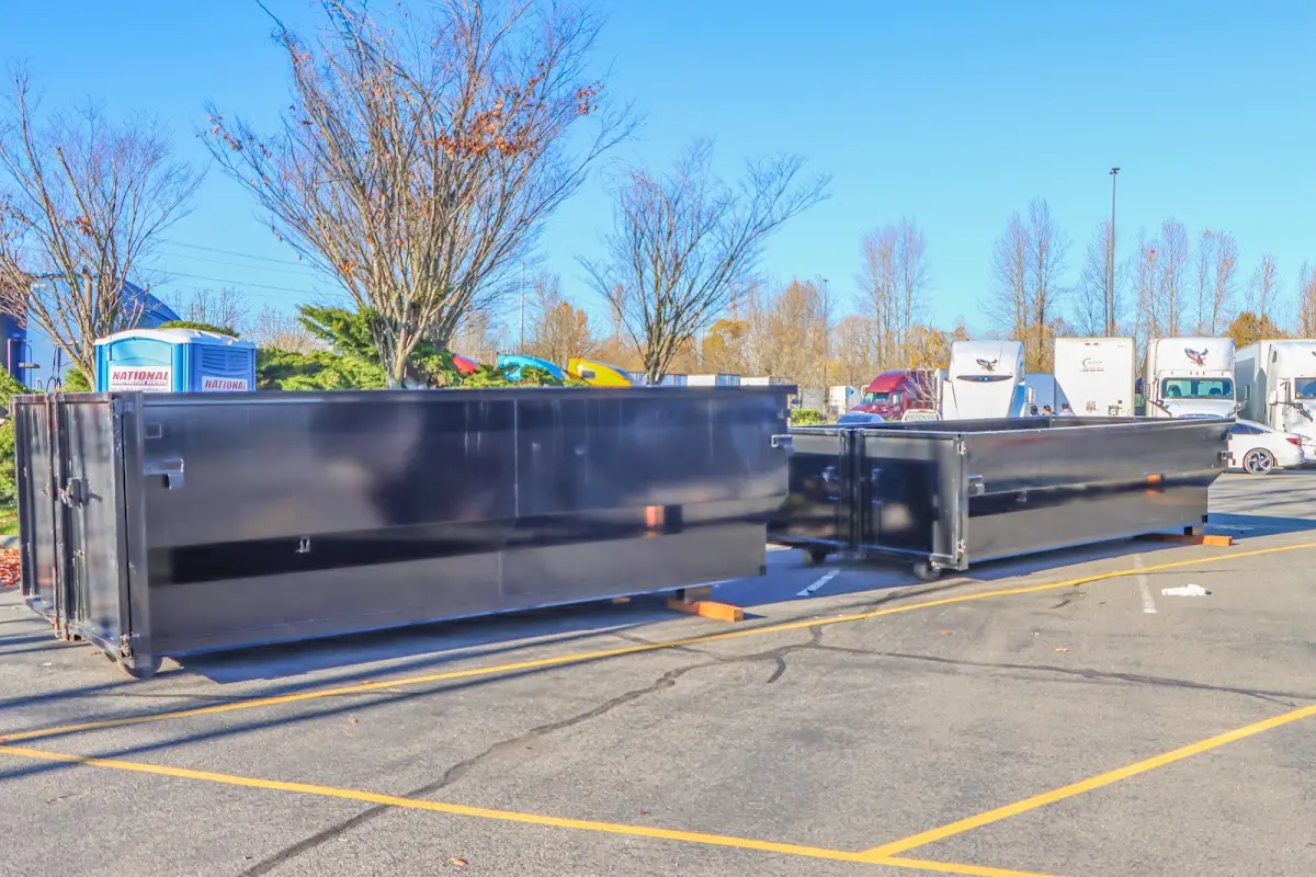 Professional dumpster rental service with roll-off container on residential driveway in Northgate